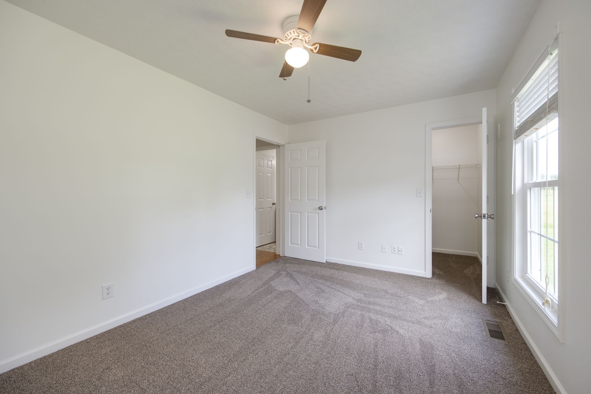 880 Denning Ford Road Portland, TN 37148 - Photo 23 of 54 wooden floor in an empty room with a window