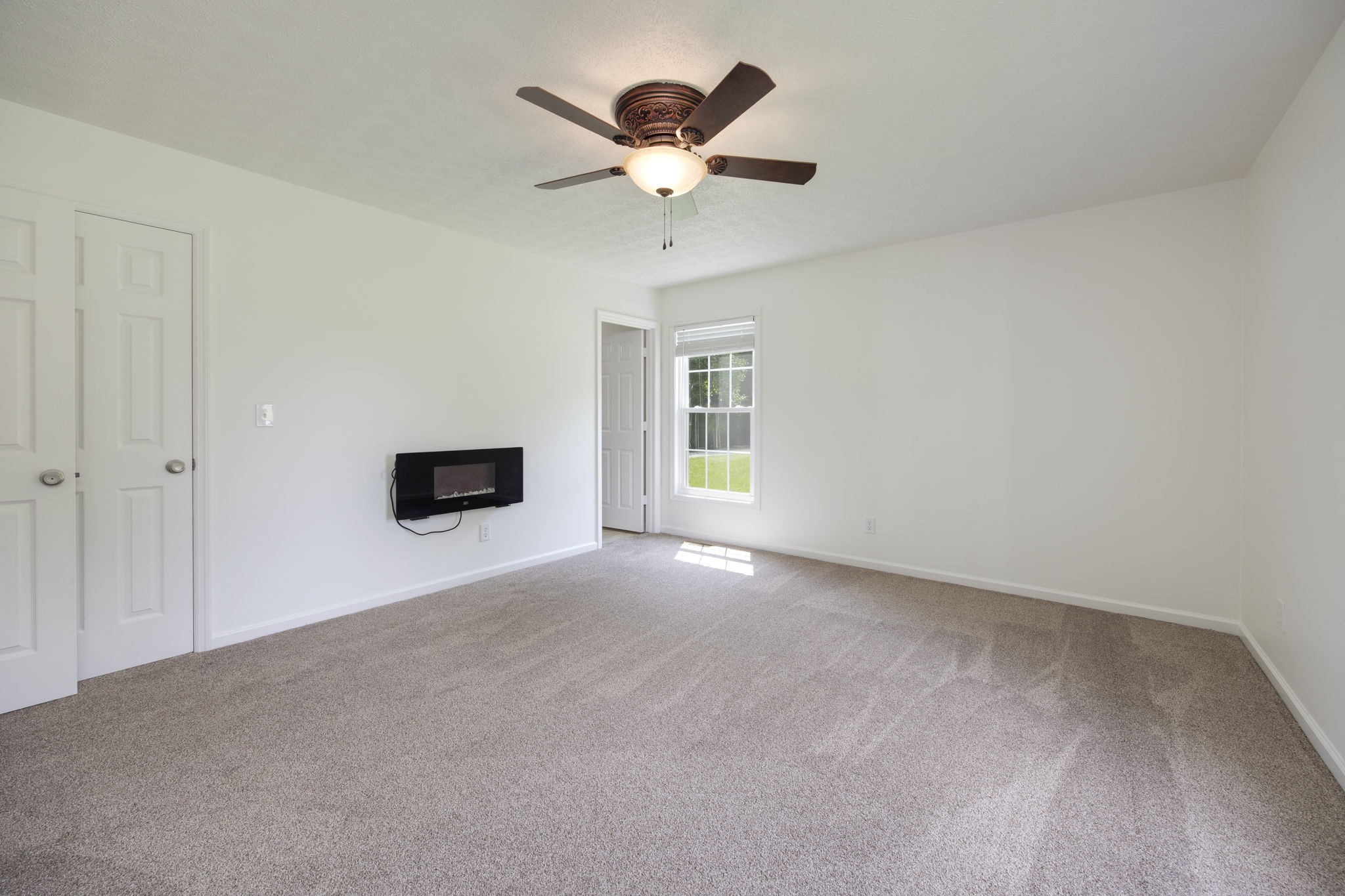 880 Denning Ford Road Portland, TN 37148 - Photo 24 of 54 a view of an empty room with a ceiling fan
