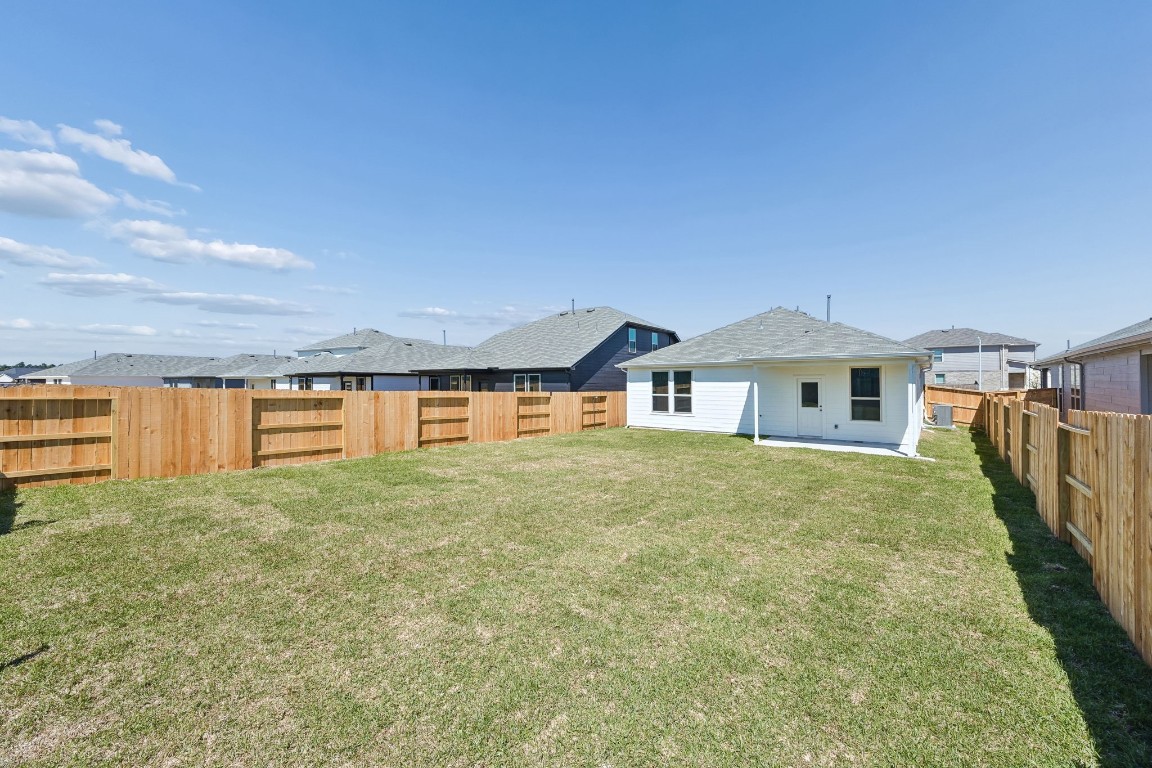 15023 Rustic Moon Road Conroe, TX 77302 - Photo 26 of 32 a front view of house with yard and trees in the background