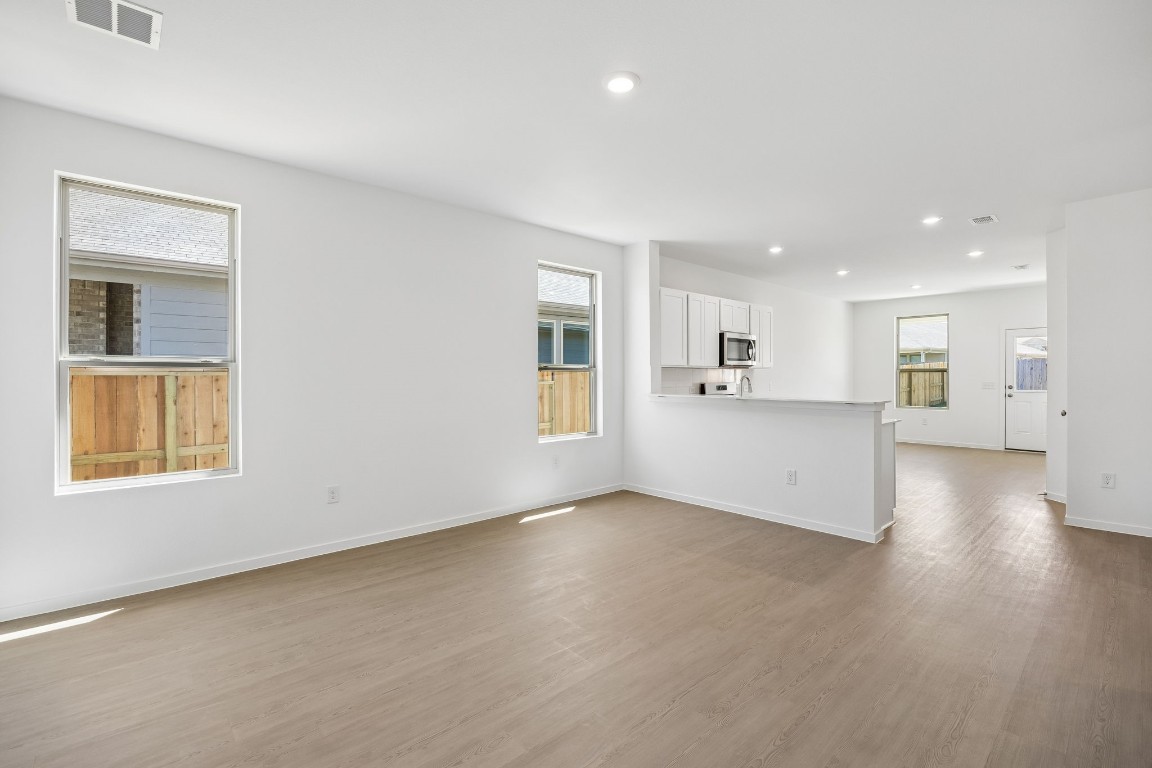 15023 Rustic Moon Road Conroe, TX 77302 - Photo 3 of 32 a view of an empty room with window and wooden floor