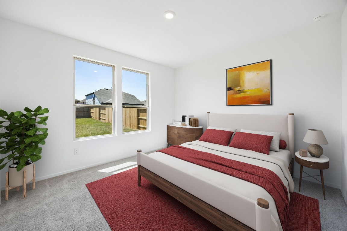 15023 Rustic Moon Road Conroe, TX 77302 - Photo 31 of 32 a bedroom with a bed and a potted plant