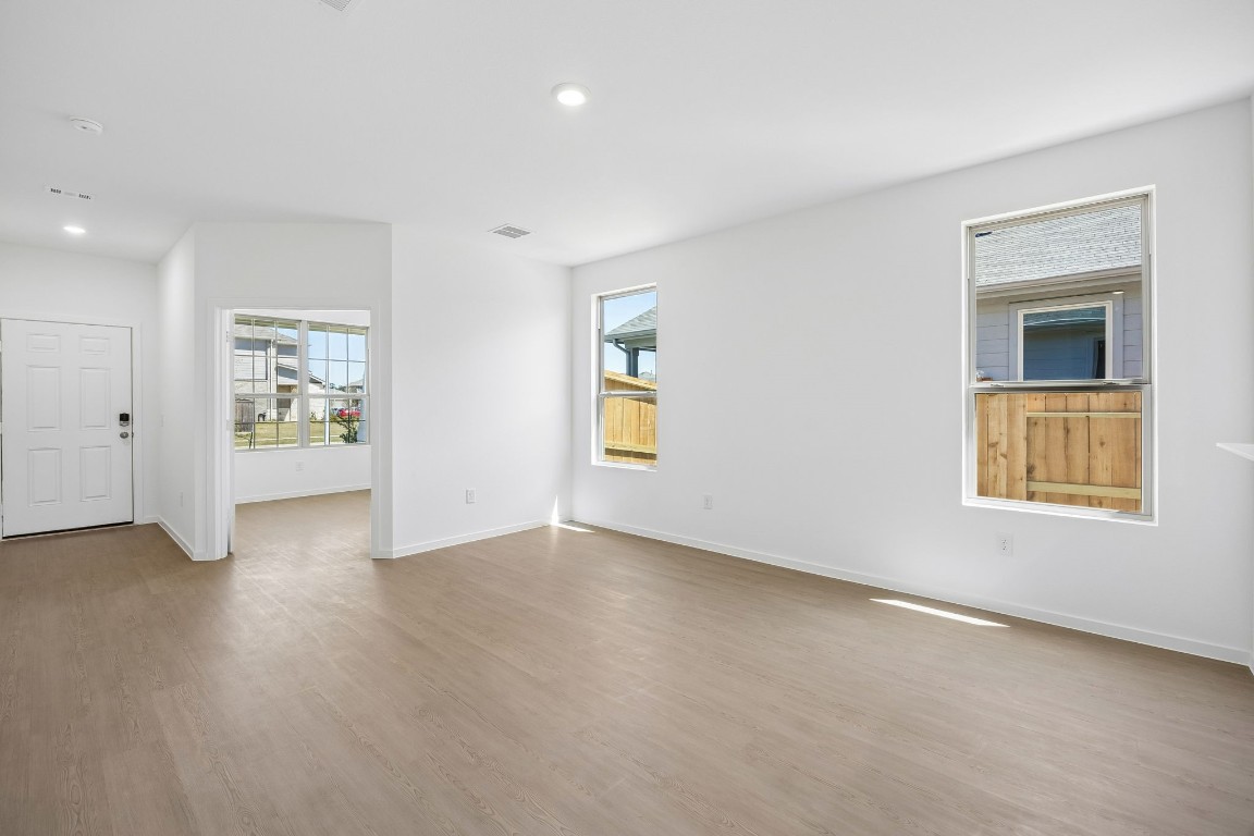 15023 Rustic Moon Road Conroe, TX 77302 - Photo 6 of 32 a view of an empty room with a window and wooden floor