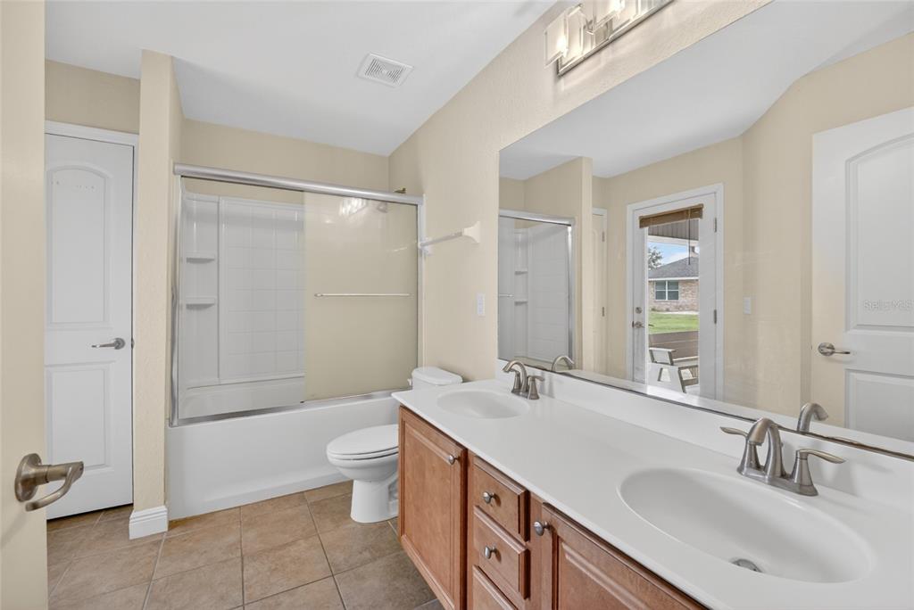 4319 Southwest 63rd Street Ocala, FL 34474 - Photo 20 of 29 a bathroom with a double vanity sink toilet and shower