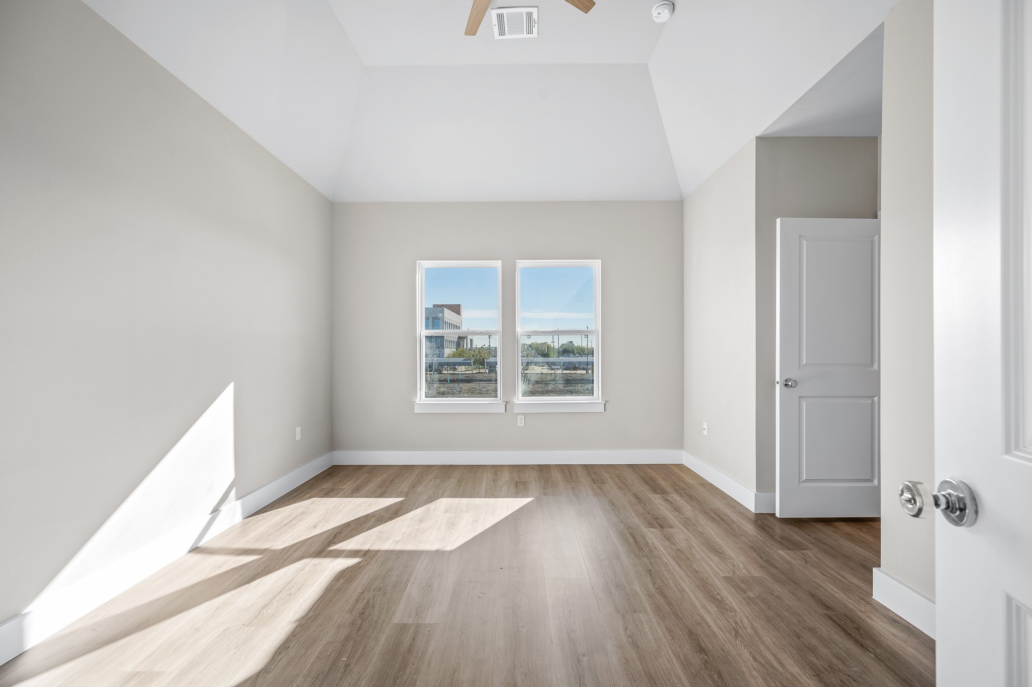 6702 Metro Boulevard, Unit 12 Houston, TX 77083 - Photo 19 of 48 an empty room with wooden floor and windows