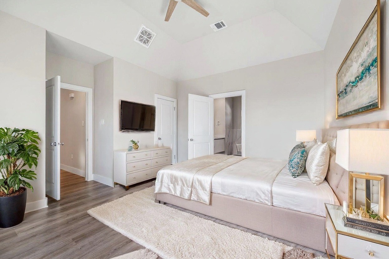 6702 Metro Boulevard, Unit 12 Houston, TX 77083 - Photo 20 of 48 a bedroom with a bed and a flat screen tv