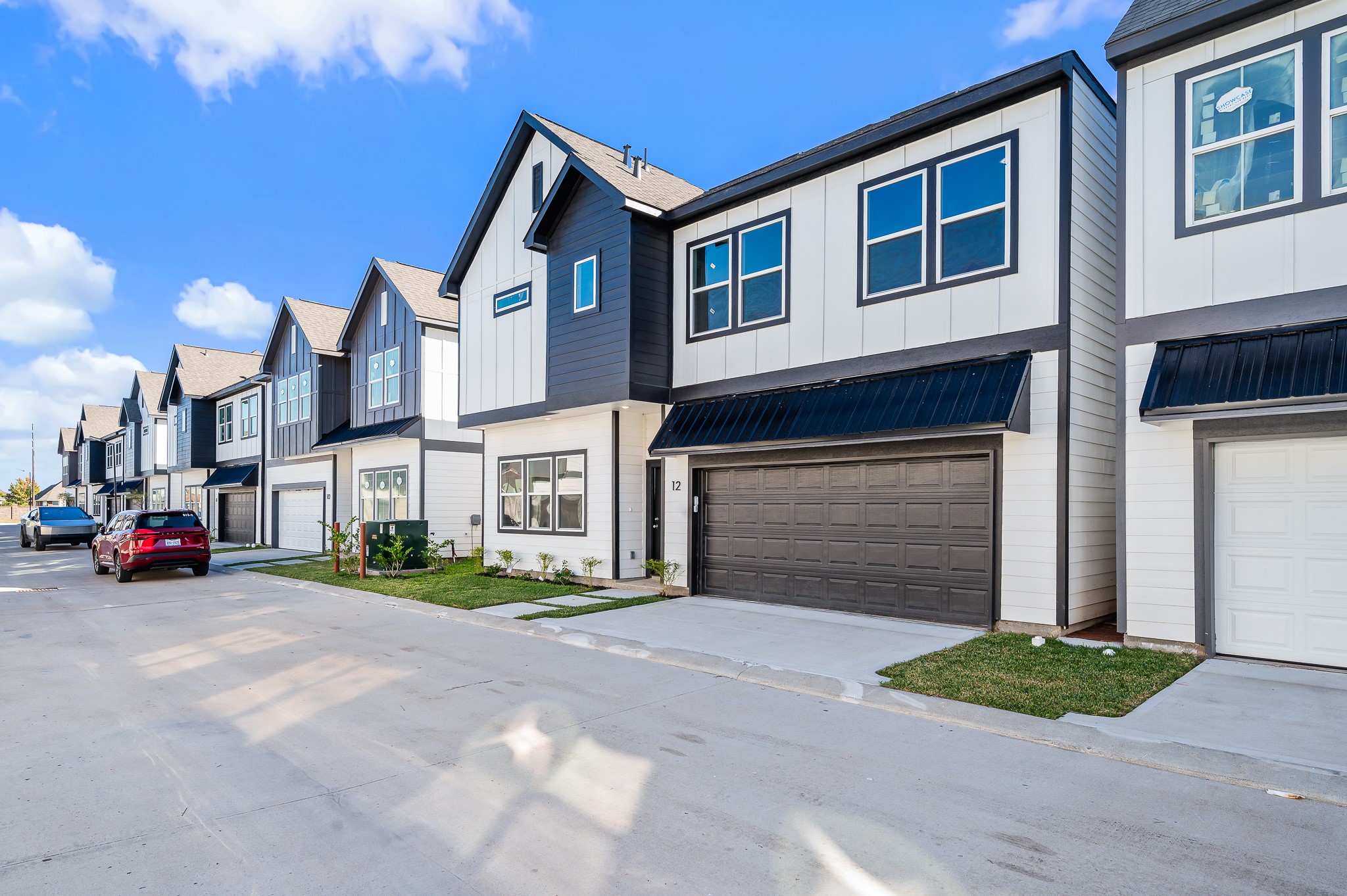 6702 Metro Boulevard, Unit 12 Houston, TX 77083 - Photo 2 of 48 a view of a brick house with a yard and large parking space