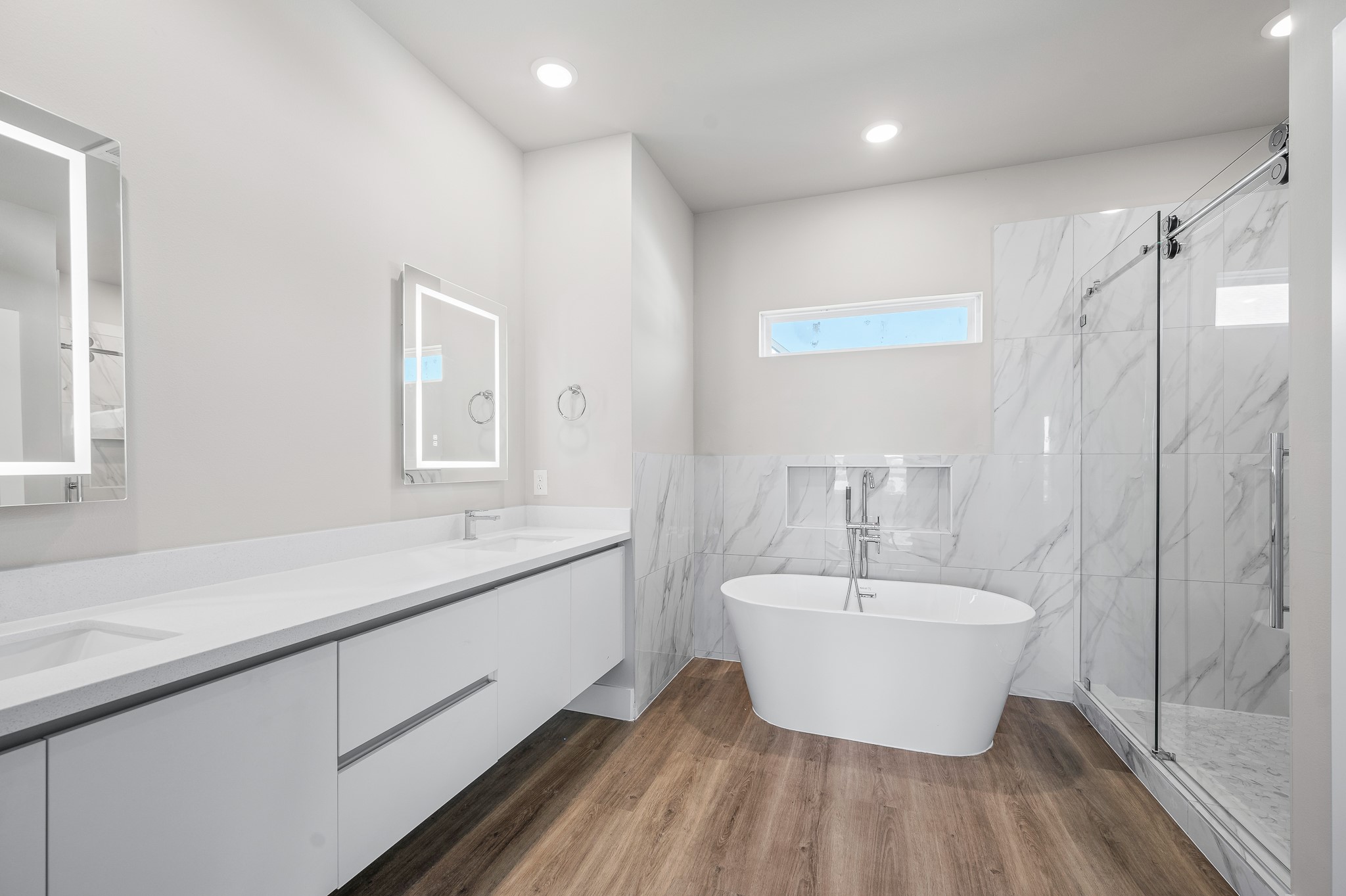 6702 Metro Boulevard, Unit 12 Houston, TX 77083 - Photo 21 of 48 a bathroom with a double vanity sink a mirror and a bathtub