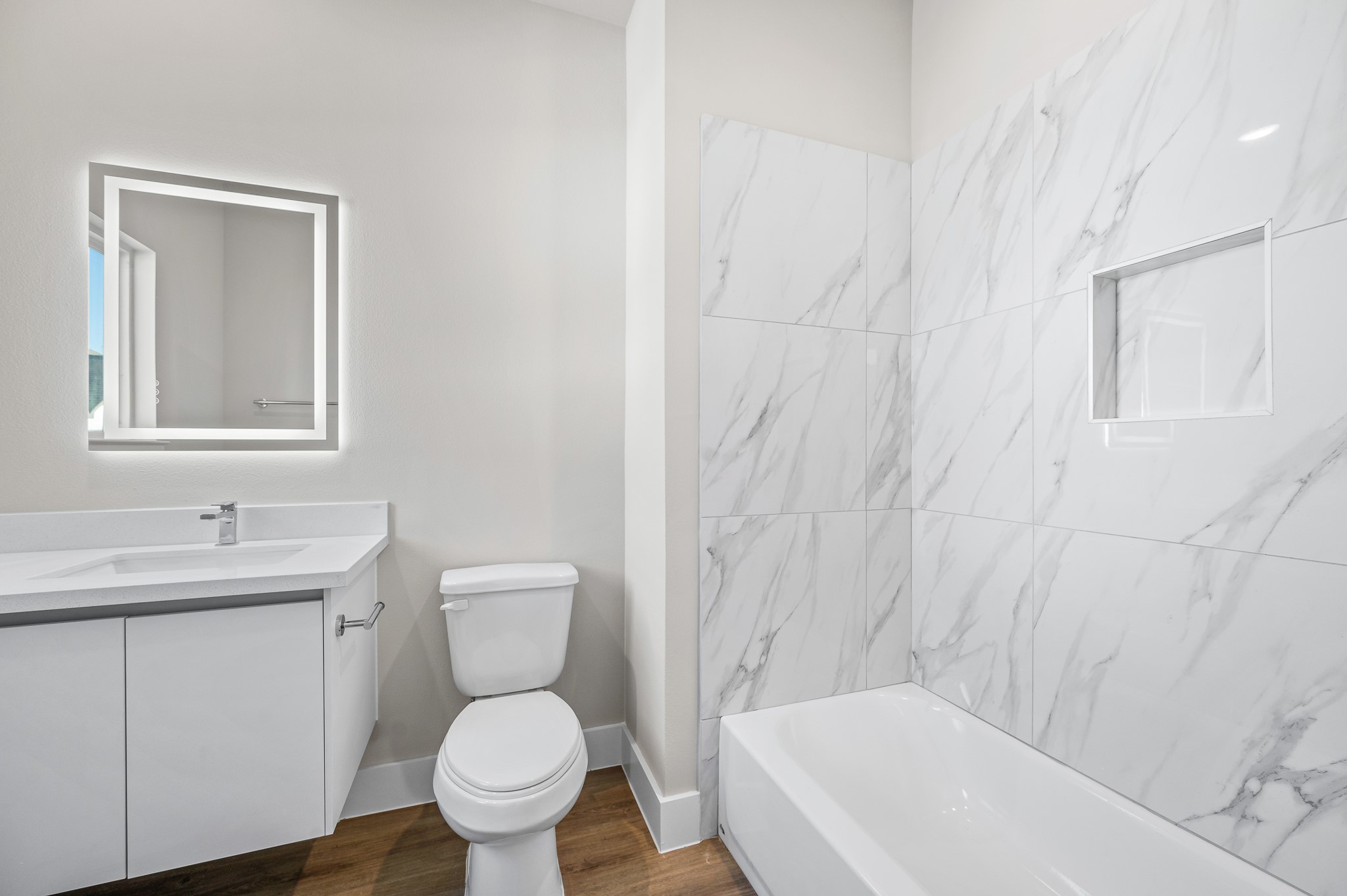 6702 Metro Boulevard, Unit 12 Houston, TX 77083 - Photo 27 of 48 a bathroom with a toilet a sink and mirror