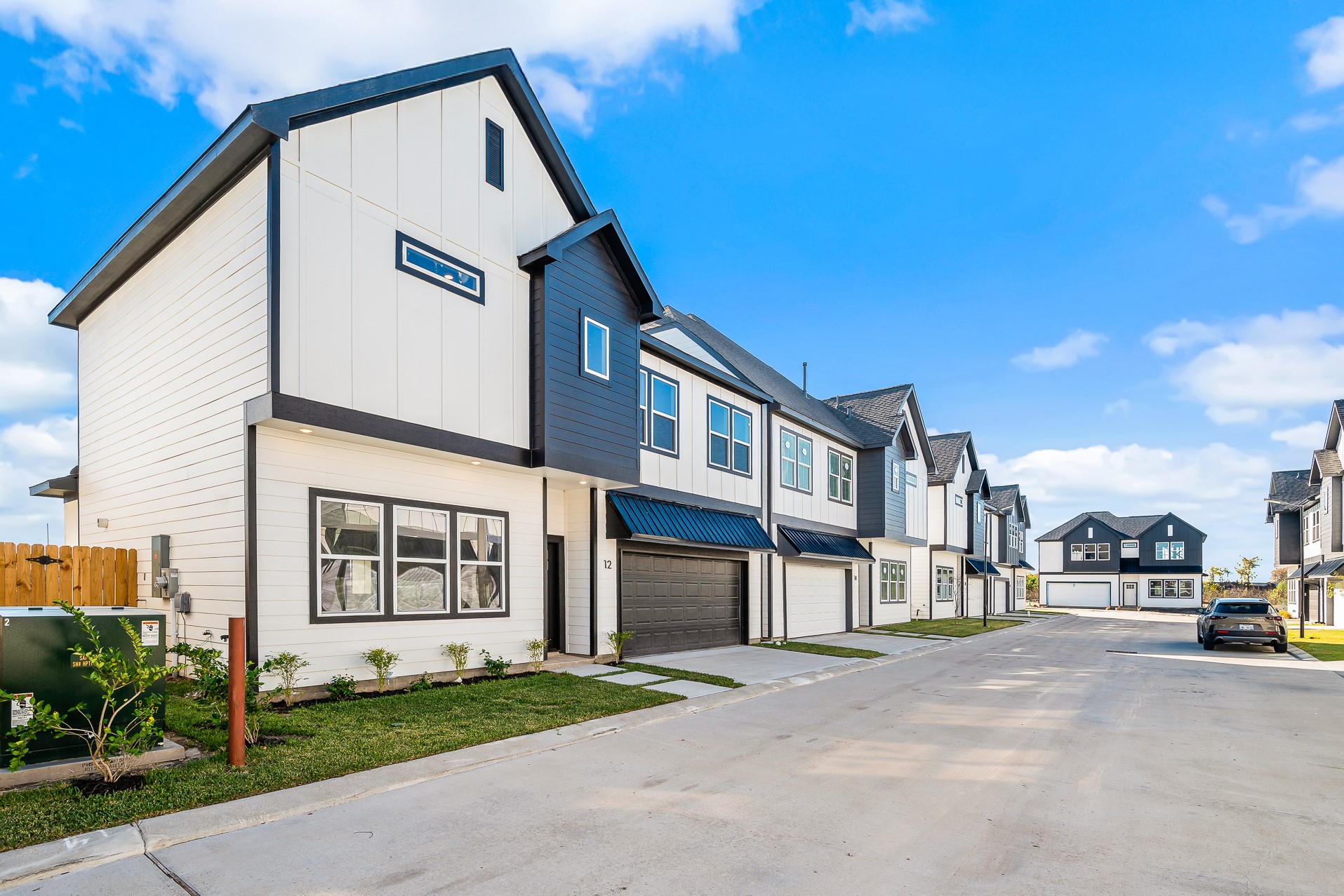 6702 Metro Boulevard, Unit 12 Houston, TX 77083 - Photo 3 of 48 a view of a white building among the street with palm trees