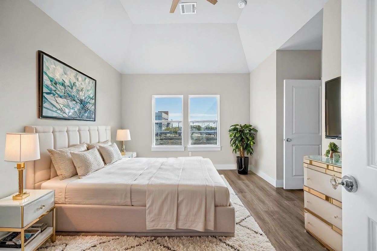 6702 Metro Boulevard, Unit 12 Houston, TX 77083 - Photo 31 of 48 a spacious bedroom with a bed a dresser and next to a window