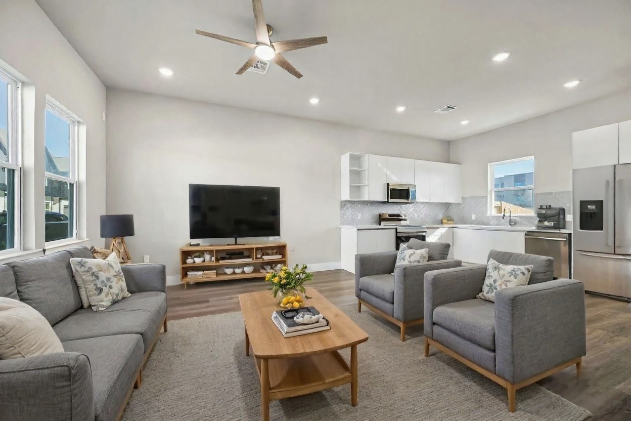 6702 Metro Boulevard, Unit 12 Houston, TX 77083 - Photo 4 of 48 a living room with furniture and a flat screen tv with kitchen view