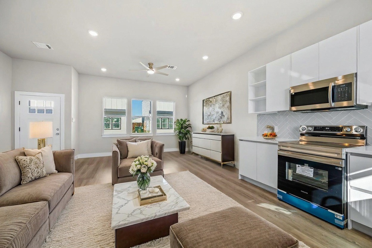 6702 Metro Boulevard, Unit 12 Houston, TX 77083 - Photo 8 of 48 a living room with furniture a fireplace and a flat screen tv