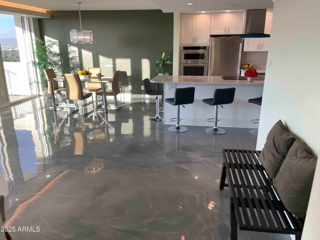 a living room with furniture and a floor to ceiling window