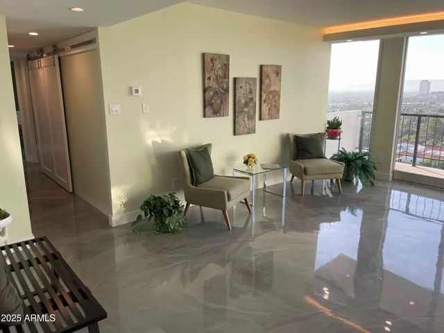 a living room with furniture and a large window