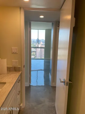 an empty room with wooden floor and entrance