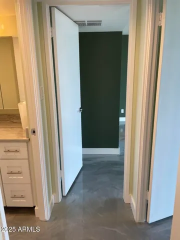 a patio with table and chairs and potted plants