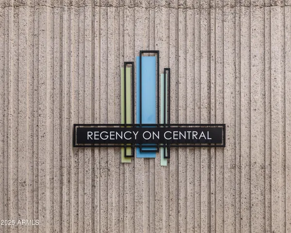 a lobby with furniture and potted plants