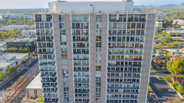 a kitchen with a sink dishwasher a stove and white cabinets with wooden floor