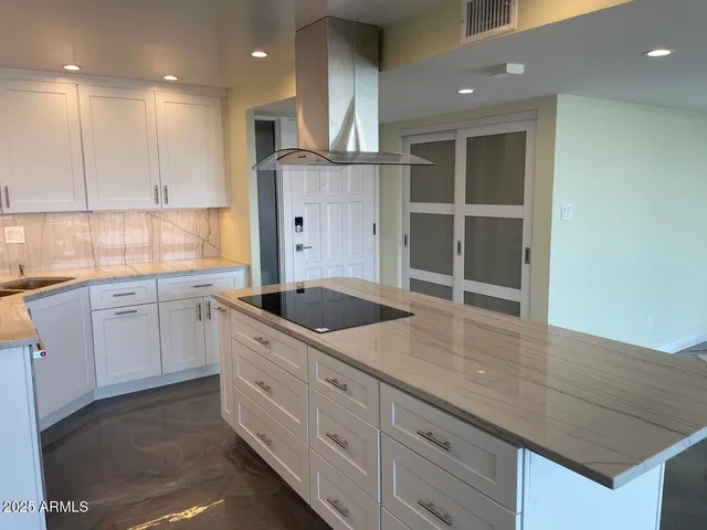 a dining room with furniture a chandelier and wooden floor