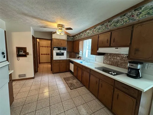 a kitchen with stainless steel appliances cabinets a sink and a counter top space