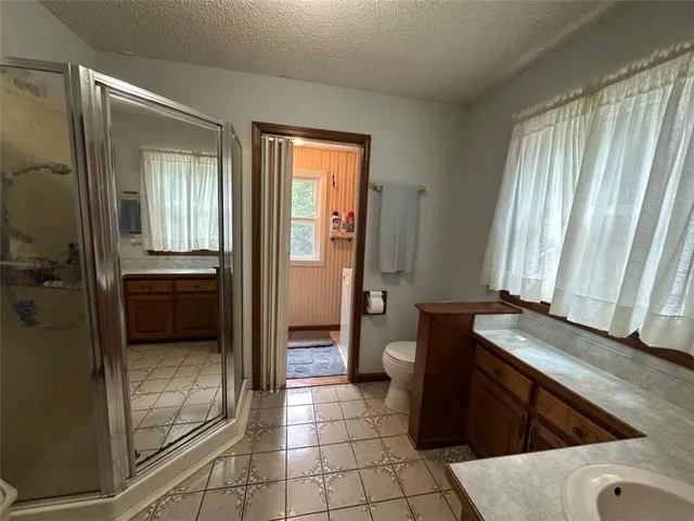 a view of a bathroom with tub and sink