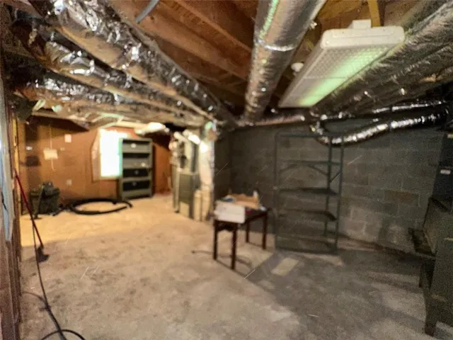 a view of water heater room with wooden walls