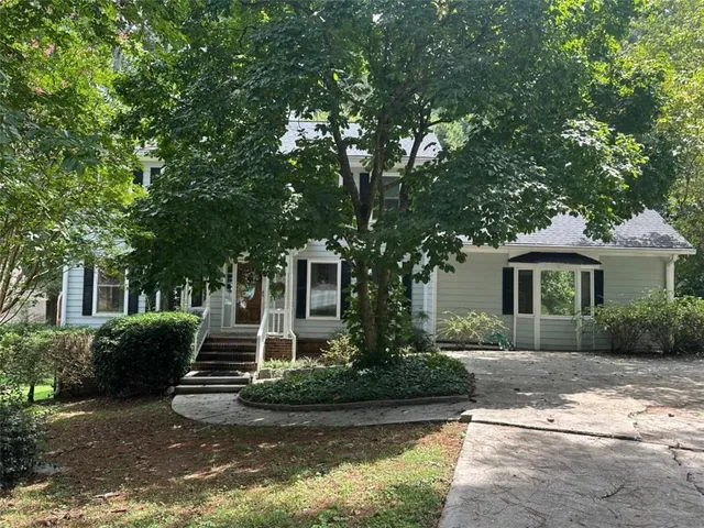 a front view of a house with garden