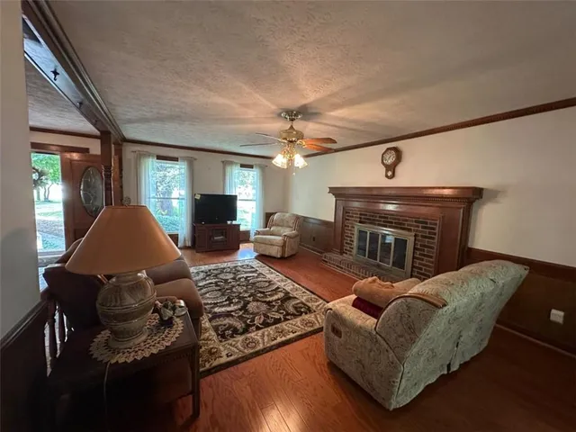 a living room with furniture a fireplace and a flat screen tv