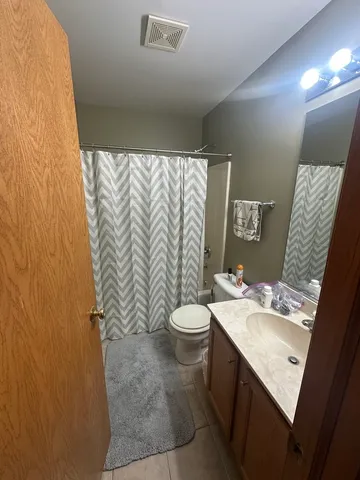 a bathroom with a sink a toilet and mirror