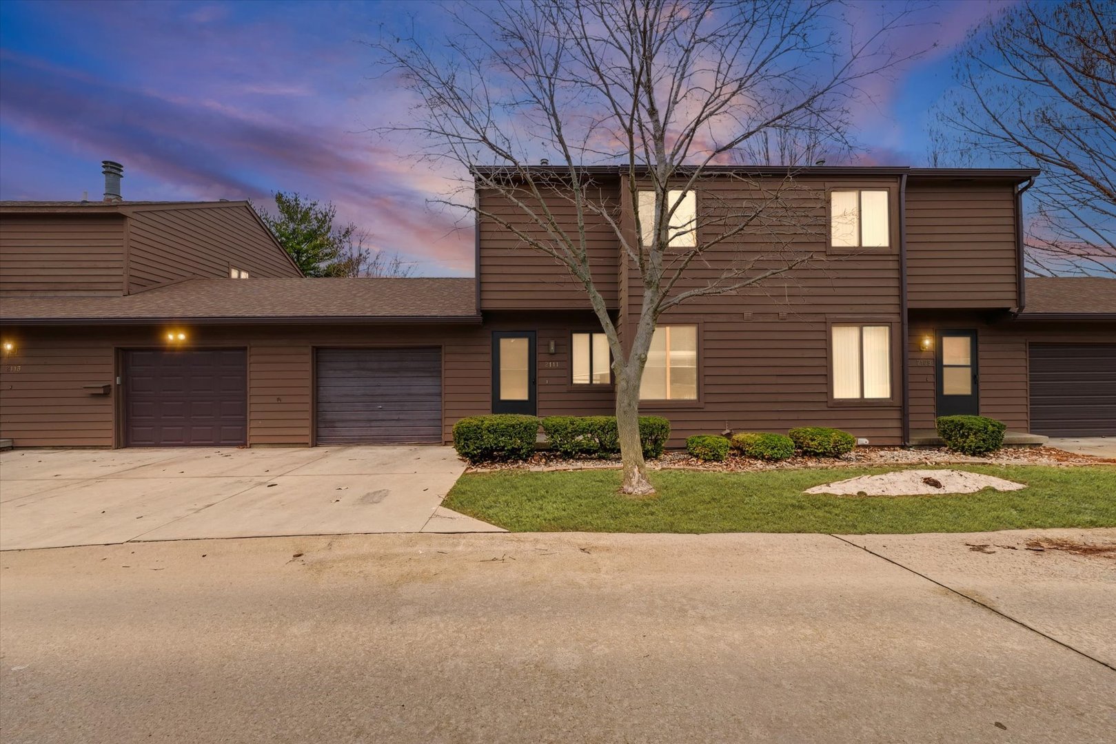 2111 Sunview Drive, Unit 2111 Champaign, IL 61821 - Photo 1 of 28 a front view of a house with a yard and garage