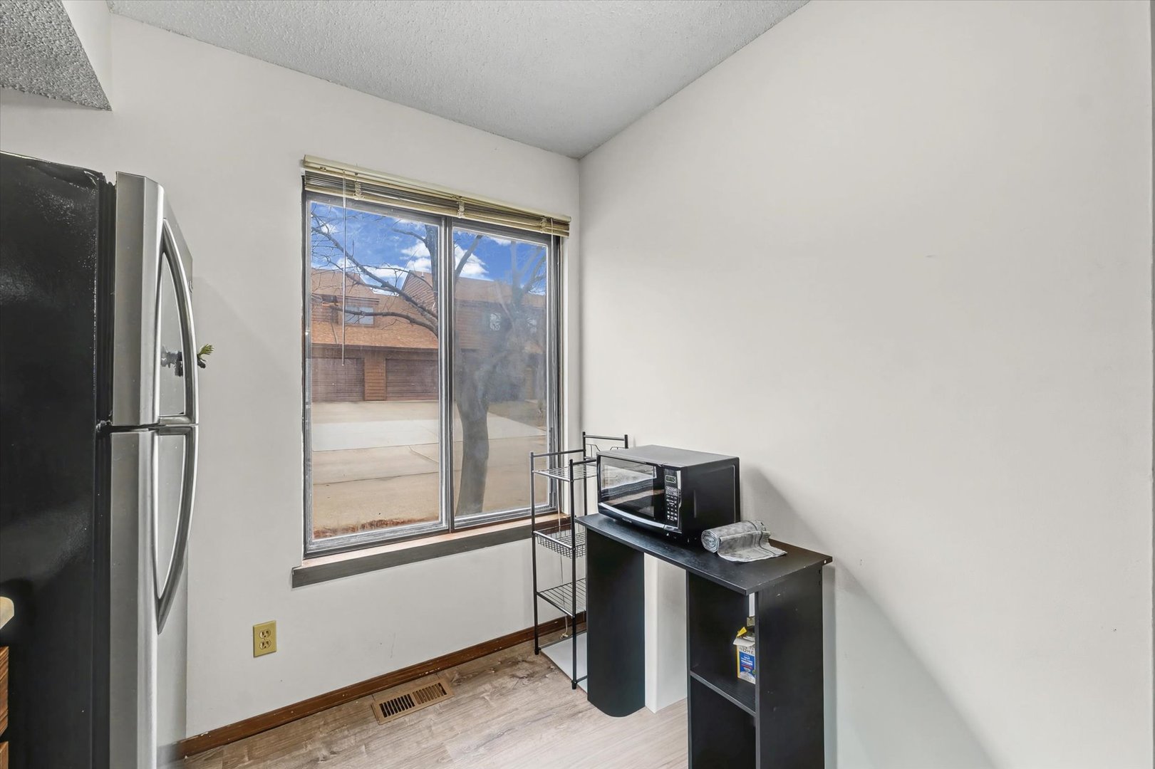 2111 Sunview Drive, Unit 2111 Champaign, IL 61821 - Photo 11 of 28 a kitchen with a refrigerator and wooden floor