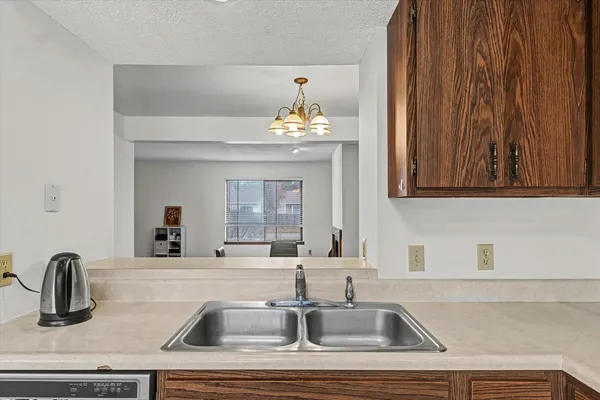 a kitchen with a sink and a mirror