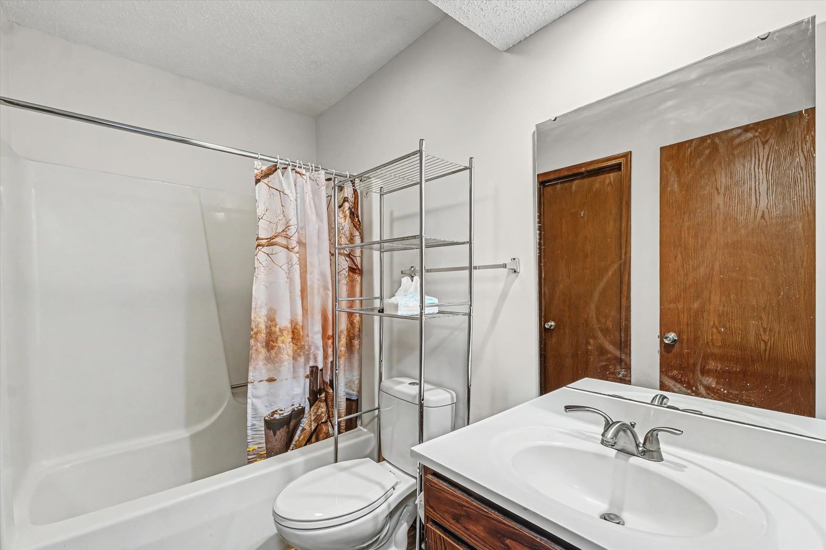 2111 Sunview Drive, Unit 2111 Champaign, IL 61821 - Photo 22 of 28 a bathroom with a sink toilet and shower