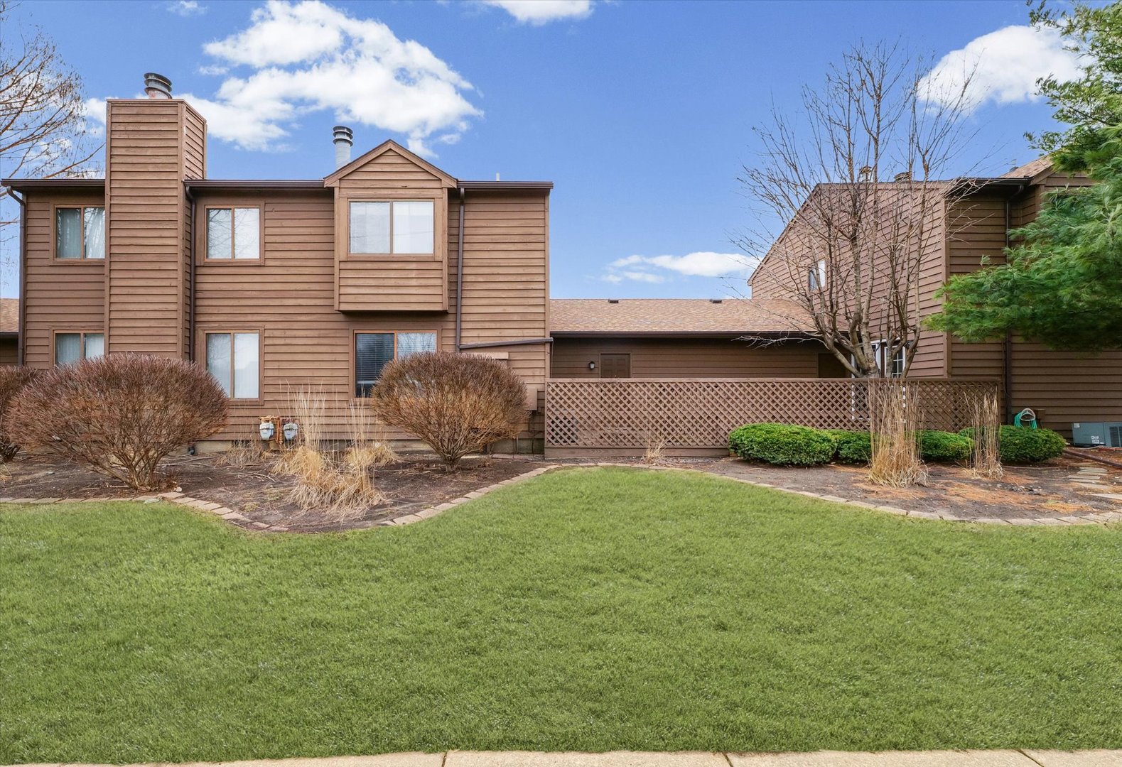 2111 Sunview Drive, Unit 2111 Champaign, IL 61821 - Photo 26 of 28 a front view of a house with garden