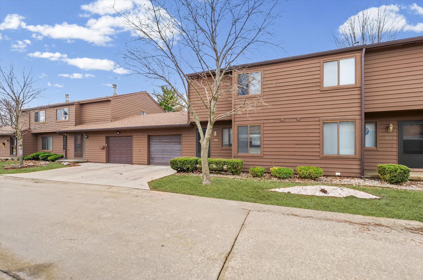 2111 Sunview Drive, Unit 2111 Champaign, IL 61821 - Photo 3 of 28 a front view of a house with garden