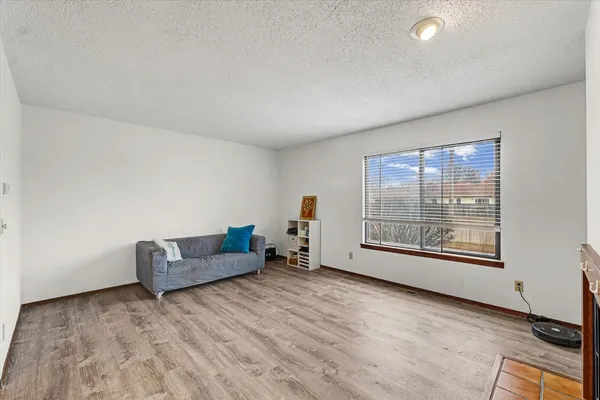 a living room with furniture and a floor to ceiling window