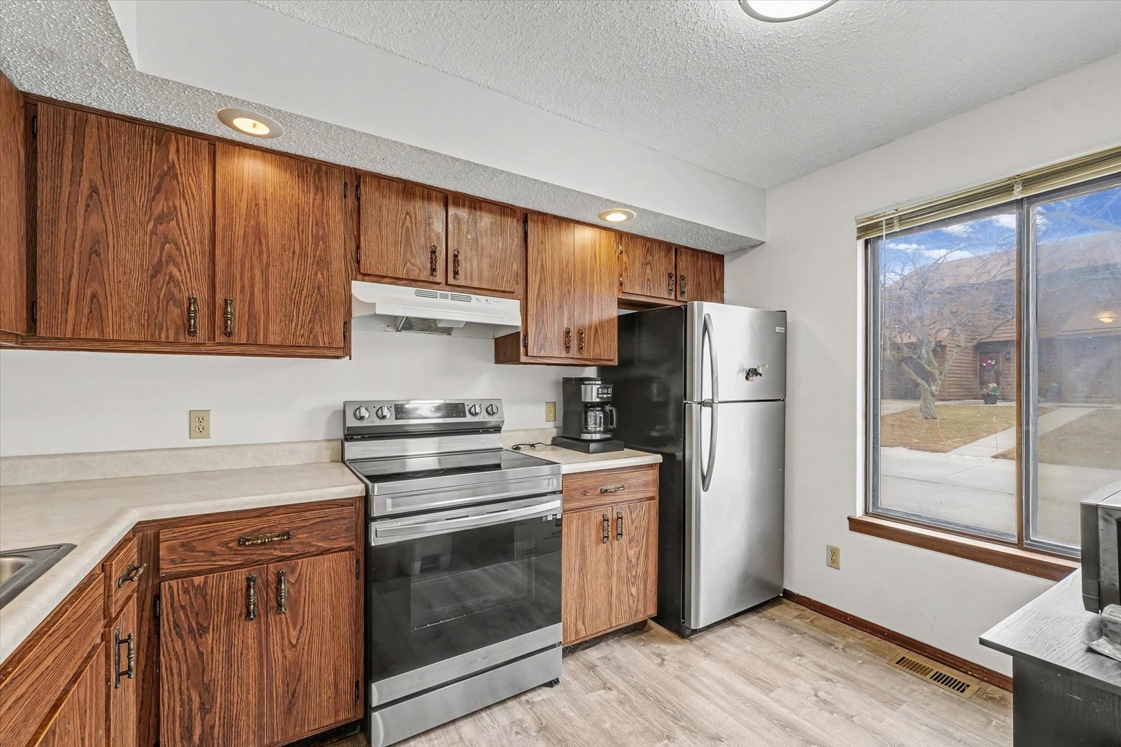 2111 Sunview Drive, Unit 2111 Champaign, IL 61821 - Photo 10 of 28 a kitchen with stainless steel appliances granite countertop a refrigerator stove and sink