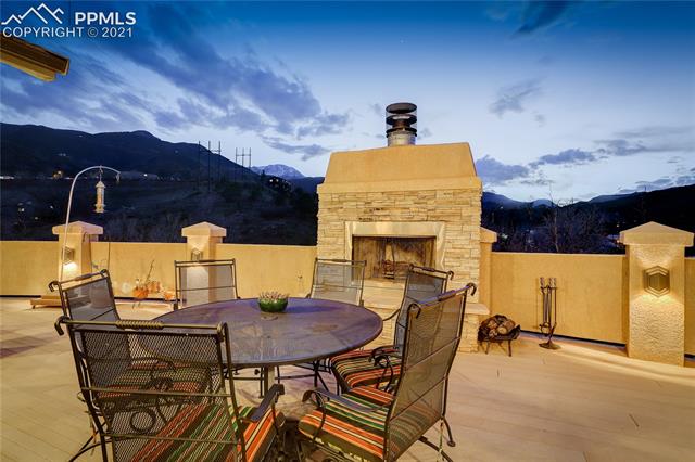 20 Keithley Road Manitou Springs, CO 80829 - Photo 14 of 42 Spacious balcony with trex flooring, built-in speakers, wood burning fireplace, built-in lighting, and sweeping mountain views.