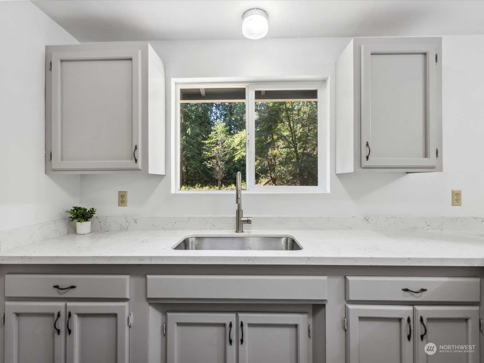 4330 200th Street Southeast Bothell, WA 98012 - Photo 11 of 36 a kitchen with a sink cabinets and window