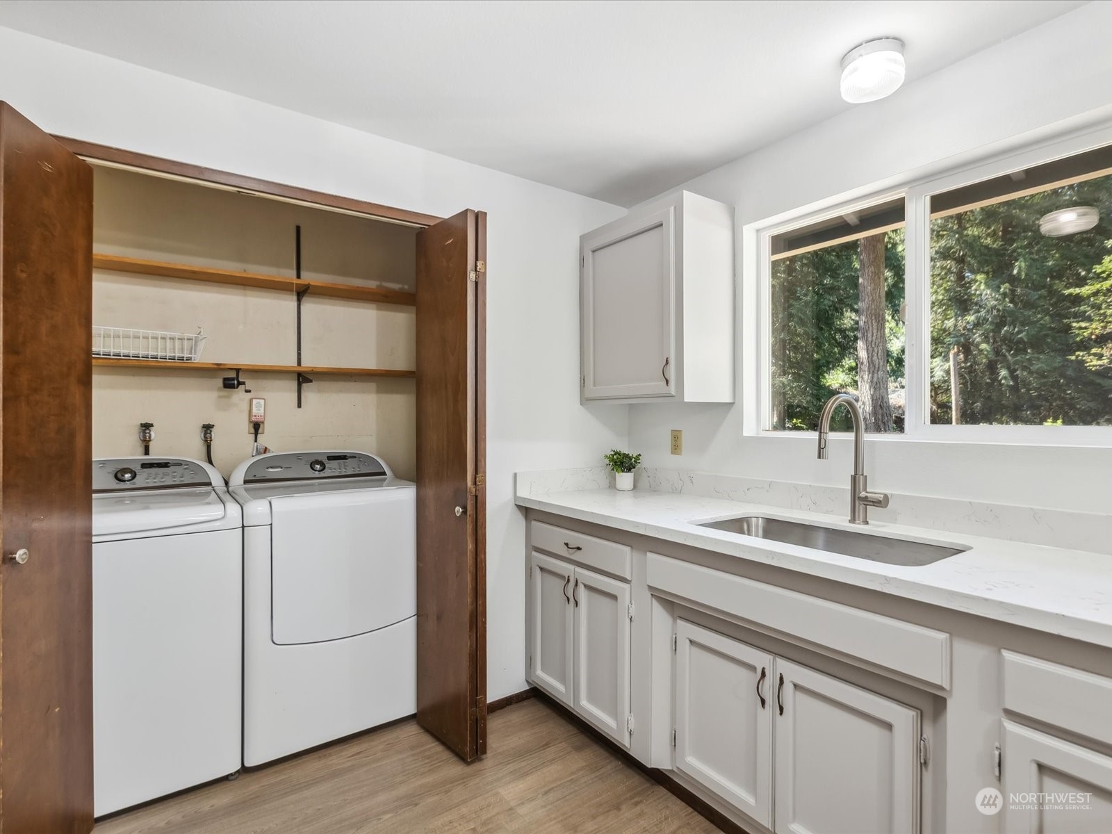 4330 200th Street Southeast Bothell, WA 98012 - Photo 13 of 36 a kitchen with sink cabinets and wooden floor