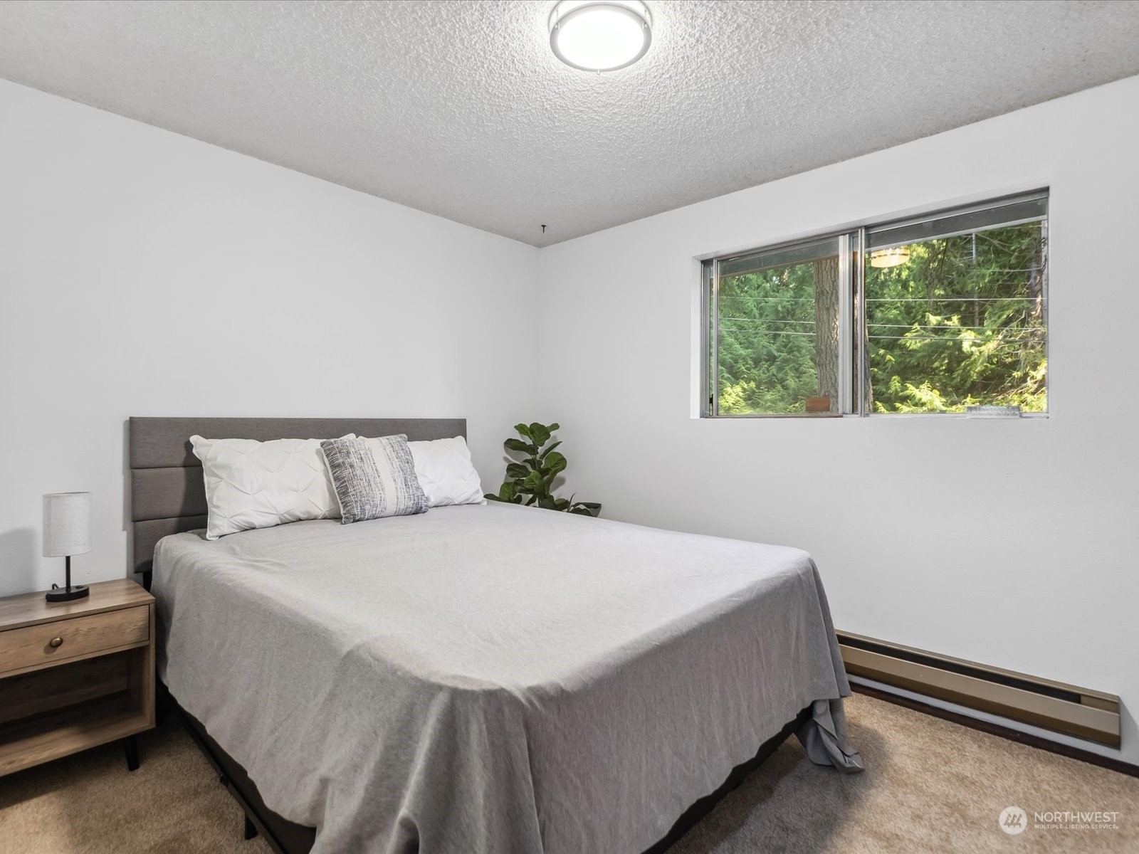 4330 200th Street Southeast Bothell, WA 98012 - Photo 15 of 36 a large bed sitting in a bedroom next to a window
