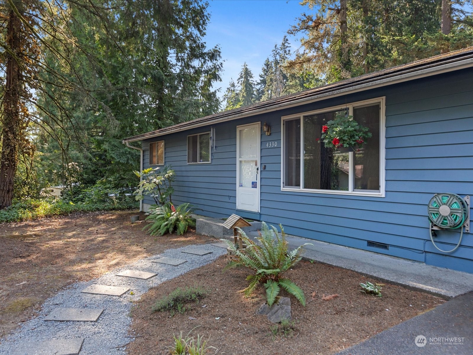 4330 200th Street Southeast Bothell, WA 98012 - Photo 2 of 36 a front view of a house with garden