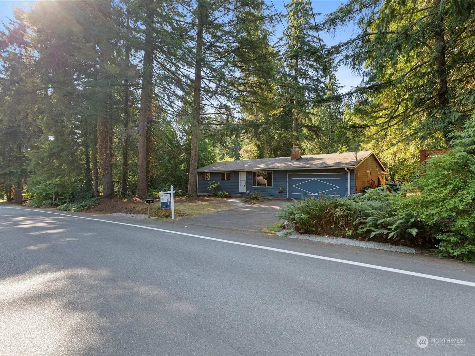 4330 200th Street Southeast Bothell, WA 98012 - Photo 27 of 36 a front view of a house with a yard and a garage