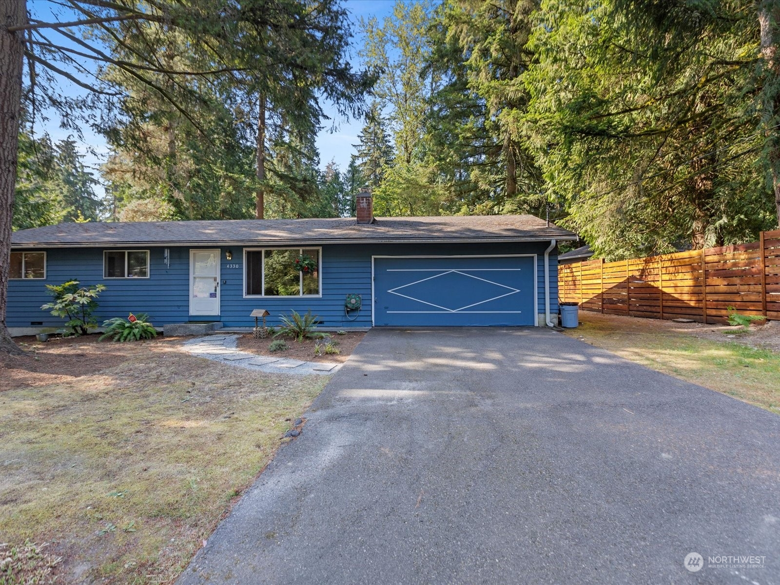 4330 200th Street Southeast Bothell, WA 98012 - Photo 28 of 36 a front view of a house with a yard and garage