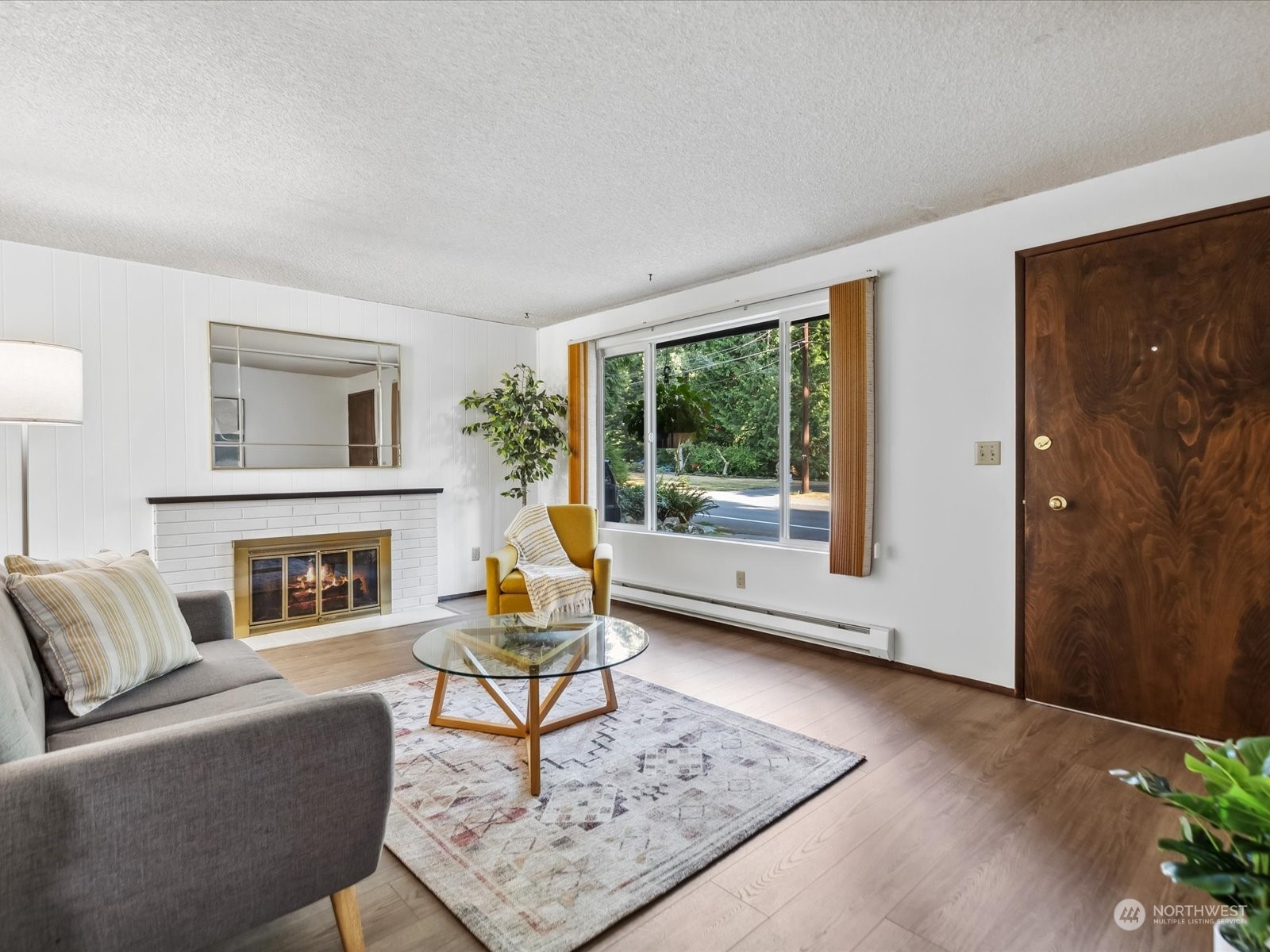 4330 200th Street Southeast Bothell, WA 98012 - Photo 6 of 36 a living room with furniture a fireplace and a table