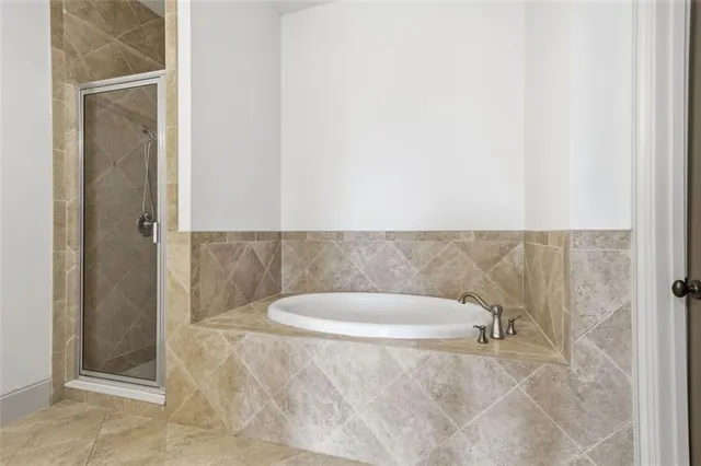 a bathroom with a granite countertop shower a mirror and a sink