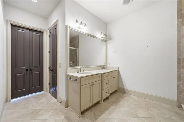 a spacious bathroom with double sink and mirror