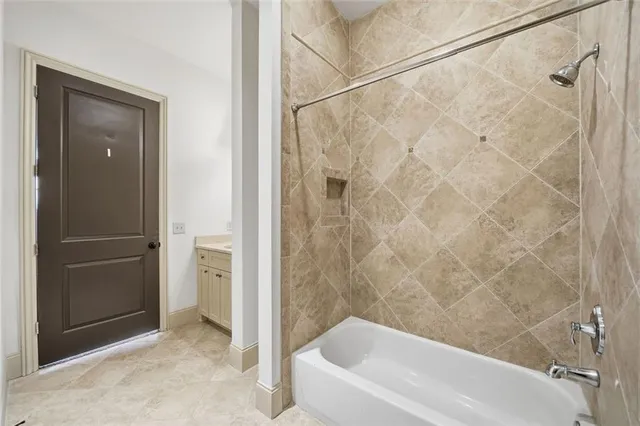 a bath tub sitting next to a white sink and a shower