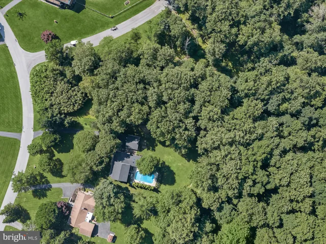 an aerial view of a residential houses with outdoor space and street view