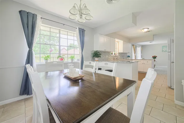 a view of kitchen and dining area with a large window